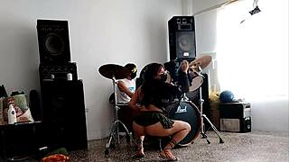 They drum while she dances, stripping her clothes and shaking that big curvy ass.