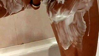 Naked stepsister soaps her big tits in the shower.