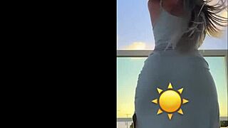hot blonde dances sexy in see-through dress teasing her curves