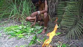 hot african native woman feels the jungle heat while cooking outdoors