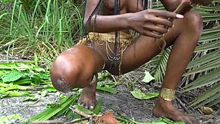 hot african native woman feels the jungle heat while cooking outdoors