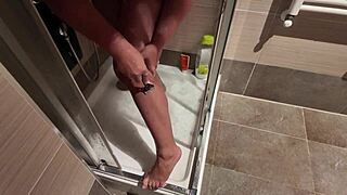 big breasted milf soaps up then shaves her hairy pussy lips smooth in steamy shower