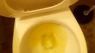 21 year old taking a piss in the toilet with a bit of penis showing