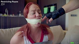 Daisy cheerleader tied and tape gagged by captor