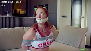 Daisy cheerleader tied and tape gagged by captor