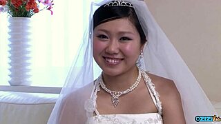 The new Asian wife, still in her wedding gown, gets a visit